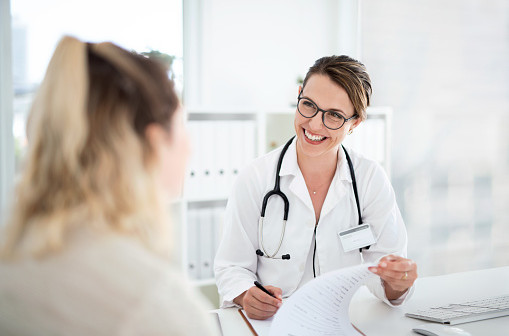 Cropped shot of an attractive young female doctor consulting with a patient inside her office at a hospital